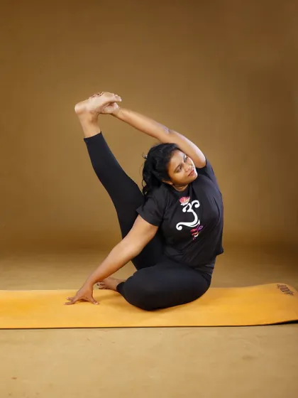 Our lead instructor, Prathima Arikeri, demonstrates an advanced posture that combines flexibility, strength, and focus. Her deep knowledge of yoga therapy and alignment ensures you practice safely and effectively, no matter your starting point.