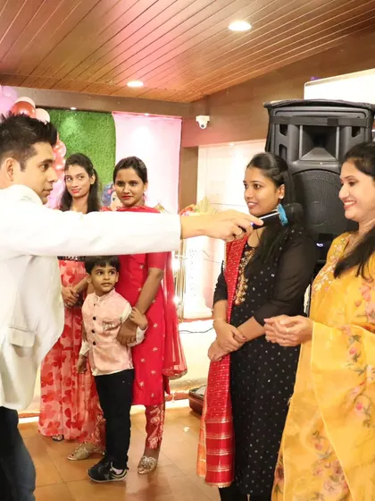 Engaging with the ladies at a birthday party, making sure the adults have just as much fun as the kids.