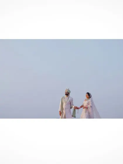 A minimalist wide shot of the couple on the beach in Goa.