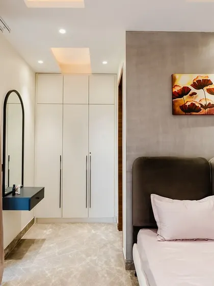 A view into the walk-in wardrobe area, which is seamlessly integrated into the bedroom design. This shows how we can maximize space without compromising on style.