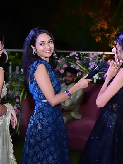 A candid moment from the Sangeeth. The outfit allows for easy interaction with guests while still looking festive.