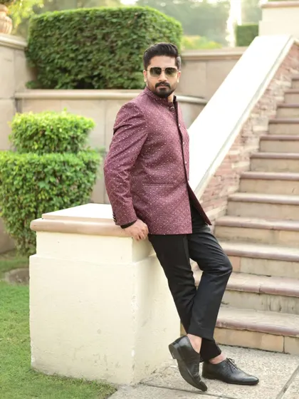 A full-length view of the custom Jodhpuri suit, showcasing its perfect fit and how it pairs with classic black trousers and formal shoes.