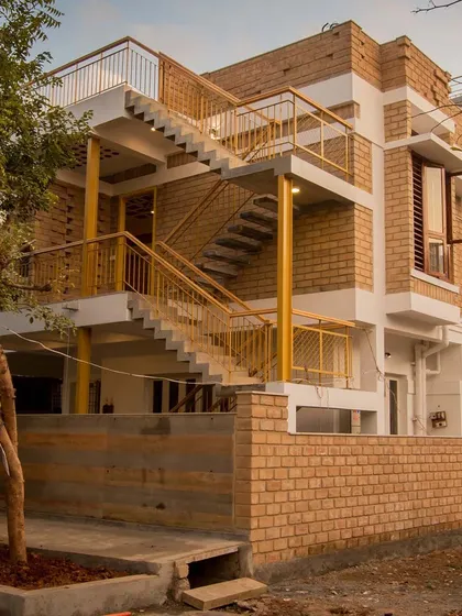 This building showcases Harmony. The repetition of the earth block material, the consistent color of the railings, and the rhythm of the staircase create a sense of unity across the entire structure.