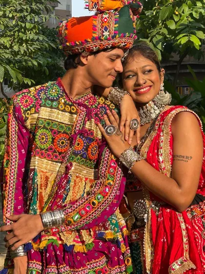 The joy of Navratri is best shared. Here you can see the detailed embroidery on the man's tunic and the beautiful silver jewelry worn by his partner.