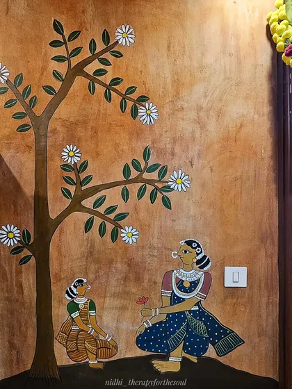A quiet, tender moment is captured here, with a mother and child sitting under a tree. It's these small, human stories that make a large mural feel personal and warm.
