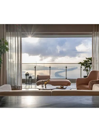 This living room in Mumbai was designed to capture the breathtaking panoramic view of the city's skyline and the sea. The interior palette is kept soft and luxurious to complement, not compete with, the view, creating a tranquil sanctuary high above the bustling city.
