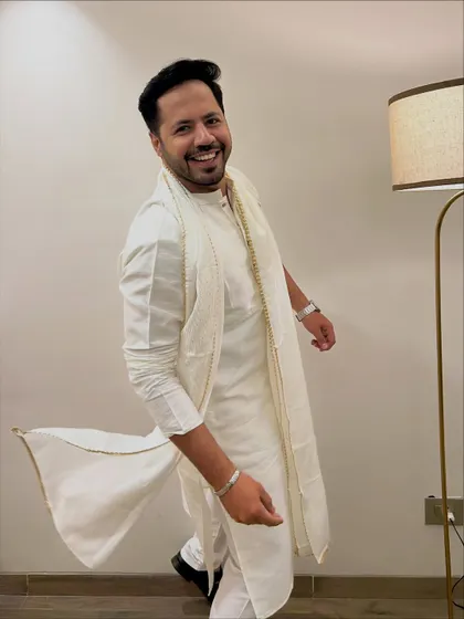 A walking, candid-style shot in the white kurta, showing the flow and grace of the outfit.