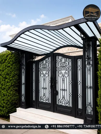 A beautiful entrance featuring a curved glass and steel canopy over an ornate gate. The wave-like design of the canopy adds a unique, modern touch to the traditional metalwork.