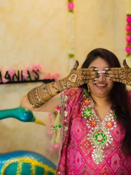 A fun and happy shot of a bride-to-be, her hands covered in beautiful henna. These are the moments that make the mehendi ceremony so special.