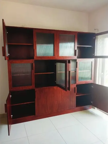 The bookshelf with all its doors open, revealing the vast amount of storage space inside. The combination of open and closed sections allows for both display and concealed storage.