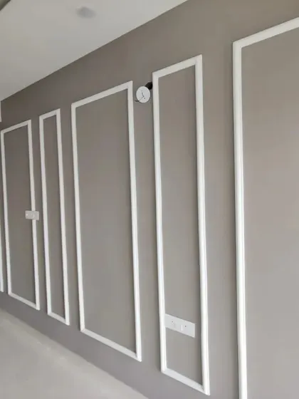 Elegant wall moulding in a contrasting white adds architectural detail and a classic, sophisticated feel to this neutral-toned hallway.