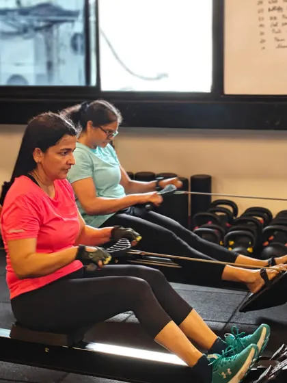 Locked in and focused. These shots capture the intensity and determination of our members during their workouts, from band work and deadlifts to dumbbell presses and rowing.