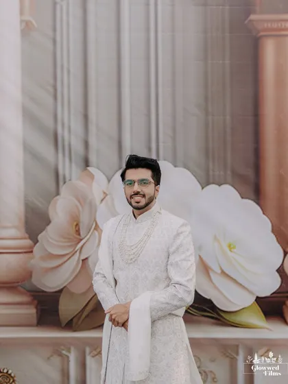 A full-length portrait of the groom, smiling and confident, ready for his wedding day.