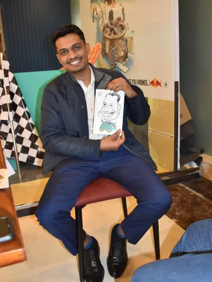Another happy participant at the Redbull event, holding his personalized caricature.