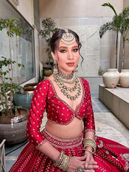 A seated portrait that allows the intricate details of the lehenga and the jewelry to take center stage.