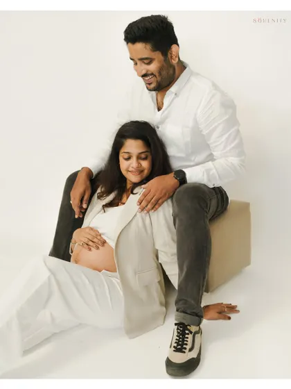 A cozy and joyful moment from a studio session. The all-white outfits create a fresh, clean look that puts all the focus on their happiness.