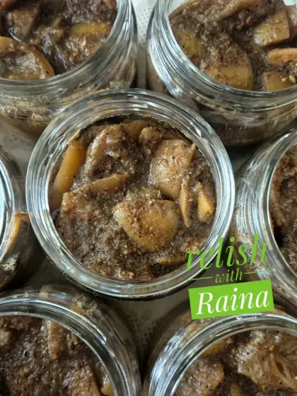 A closer look at the texture of the black lemon pickle. The lemon pieces are coated in a thick, dark masala. It's a sour and medium-spicy pickle that is a traditional Rajasthani delicacy.