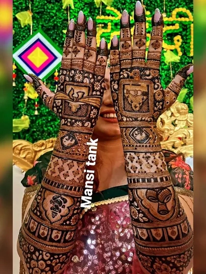 This full coverage bridal design is filled with symbols of marriage and celebration. It includes depictions of a dhol, shehnai, and kalash, making it perfect for a wedding.