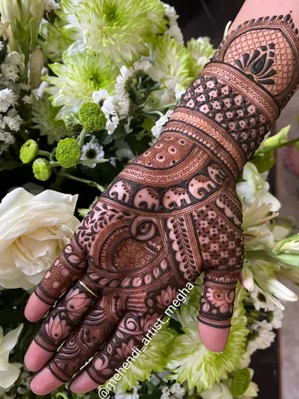 A simple yet elegant design for a family member or a smaller function. It features a prominent lotus motif on the wrist, surrounded by elephant and checkerboard patterns.