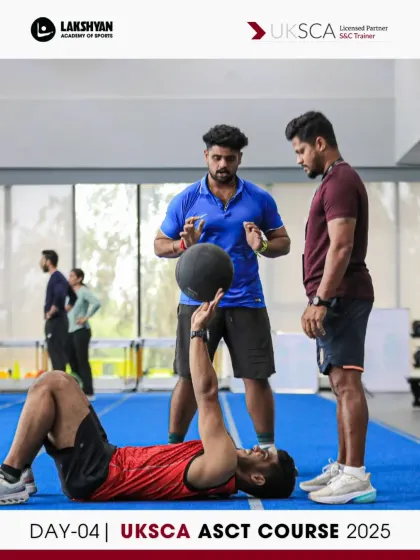 Participants practice coaching a medicine ball chest pass from a floor position, an exercise that develops explosive upper body power.