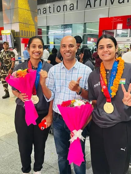 Thumbs up for the champions! Our coach and athletes celebrate their victory at the airport. The garlands and flowers are a small token of our immense pride and appreciation.