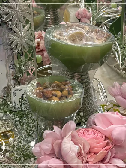 A close-up of the pastel green dry fruit bowls, part of a custom Sagan hamper. The unique color and silver-plated base make them a beautiful and useful keepsake for your guests.