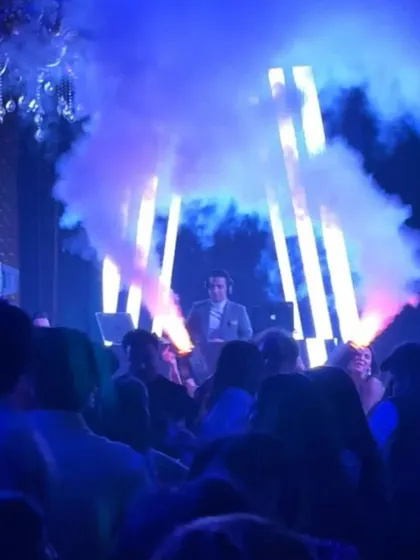 Surrounded by a packed dance floor and dramatic smoke effects. This is the view from my console during the peak of a massive wedding celebration, a moment filled with pure energy.