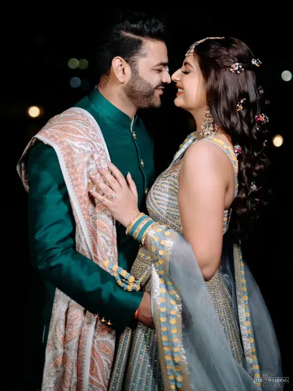 A sweet, romantic moment between the couple at their Mehendi. The soft lighting and beautiful decor created the perfect backdrop.