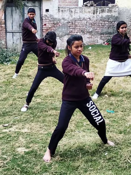 A group of my young female students practicing their stances during an outdoor training session. Together, they build not just individual skill but a community of support and shared strength. This is what building confidence through martial arts looks like.
