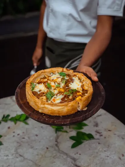 A freshly baked Puffizza, ready to be served. The golden crust and generous toppings make it a visually appealing and delicious addition to any party menu.