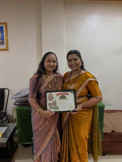 A proud moment, awarding a certificate to a successful student. She is now ready to start her own floral jewellery business.
