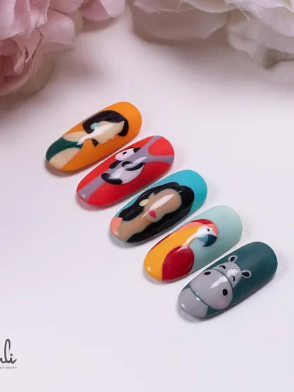 A fun and quirky set of hand-painted nails featuring abstract portraits and cute animals like a parrot and a hippo.