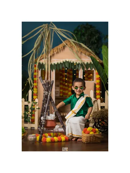 A cool little dude in sunglasses enjoying the Pongal festival vibes.