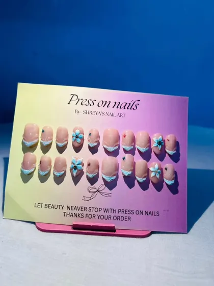 I love working with 3D elements to make the nail art pop. This set features delicate, hand-sculpted shell flowers on a French manicure base, perfect for a beach vacation or a unique summer look.