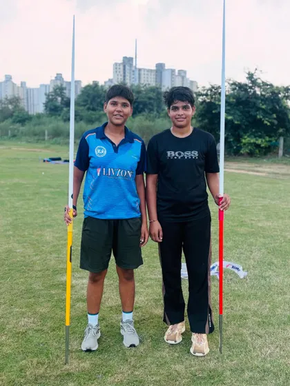 We build powerful throwers. Two of our dedicated javelin athletes posing with their equipment during a training session. We focus on developing both raw power and precise throwing technique.