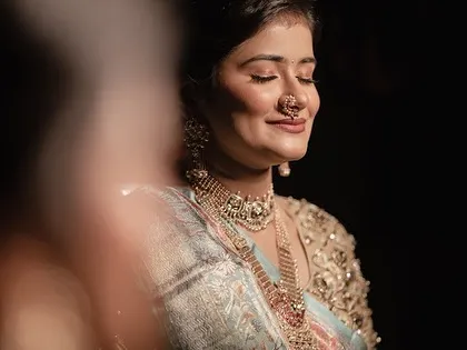 A serene moment for the bride. The makeup is soft and glowing, creating a look of timeless elegance.
