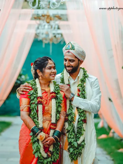 The couple walking down a beautifully decorated aisle. This shot captures the grandeur of the wedding decor and the happiness of the newlyweds.