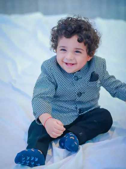 A happy moment captured. This little boy's joyful expression says everything about how comfortable and special he feels in his Vern Kids outfit.