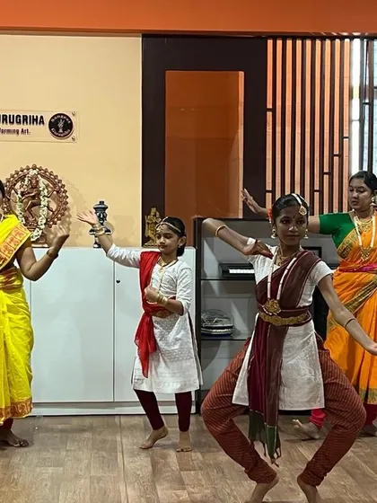 A group of students practicing a Bharatanatyam piece. The aramandi (half-seated posture) is fundamental to this dance style, and our students work hard to master it.