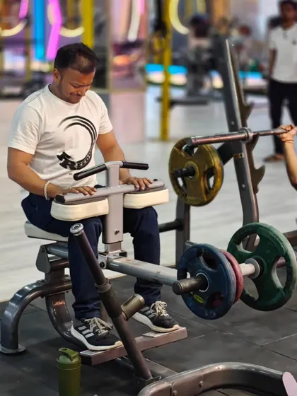 A client works on his calf muscles using the seated calf raise machine. We believe in balanced development, ensuring no muscle group is left behind.