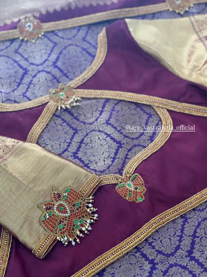 A purple and gold blouse showcasing a unique back design with kemp stone motifs. This piece is perfect for brides who want a statement back.