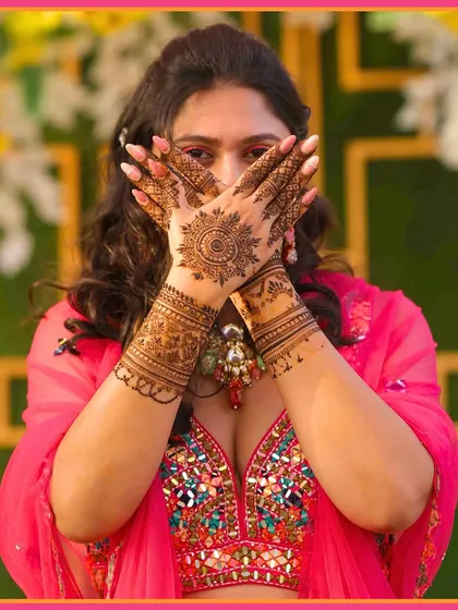 Her hands are a canvas of love. A beautiful shot of the bride showing off her detailed Mehendi design.