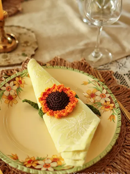 A single place setting from the sunflower tablescape, showing how the handmade napkin tie complements the vintage floral plate.