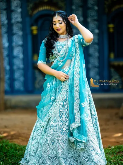 A full-length view of the sky blue lehenga, showing the beautiful flare of the skirt and the delicate lace border on the dupatta.