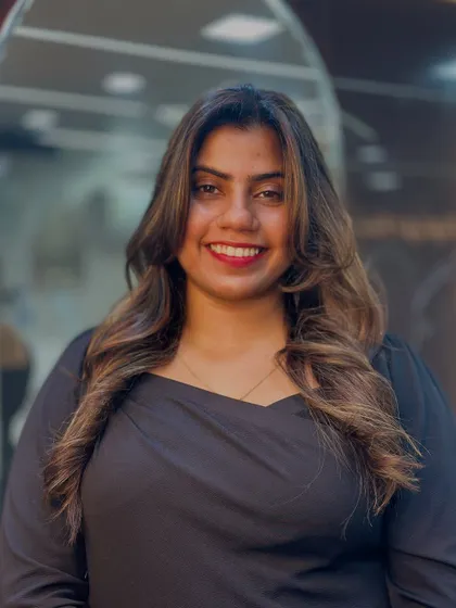 A radiant smile from a happy client. Her soft, subtle highlights and face framing layers give her a warm and approachable look.