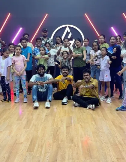 A large and energetic group of kids and adults after a successful workshop.