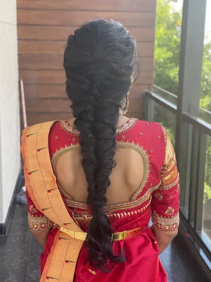 This thick, neatly plaited fishtail braid is a work of art. It's a stunning choice for a bride who wants a modern yet intricate hairstyle.