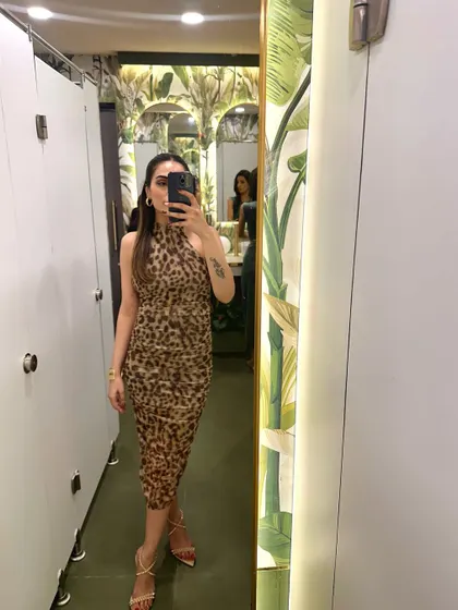 A mirror selfie in a chic leopard print halter dress. This is a great option for a night out.