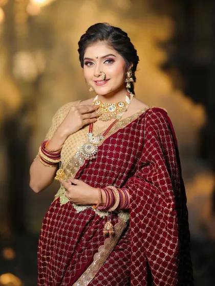 The complete look, highlighting the beautiful velvet saree and traditional gold jewelry. We aim to create looks that are both authentic and feel modern.