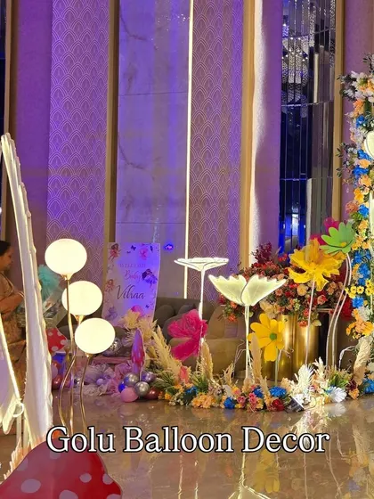 A wide view of the enchanted garden decor, with unique light-up flower props and butterfly wing elements.